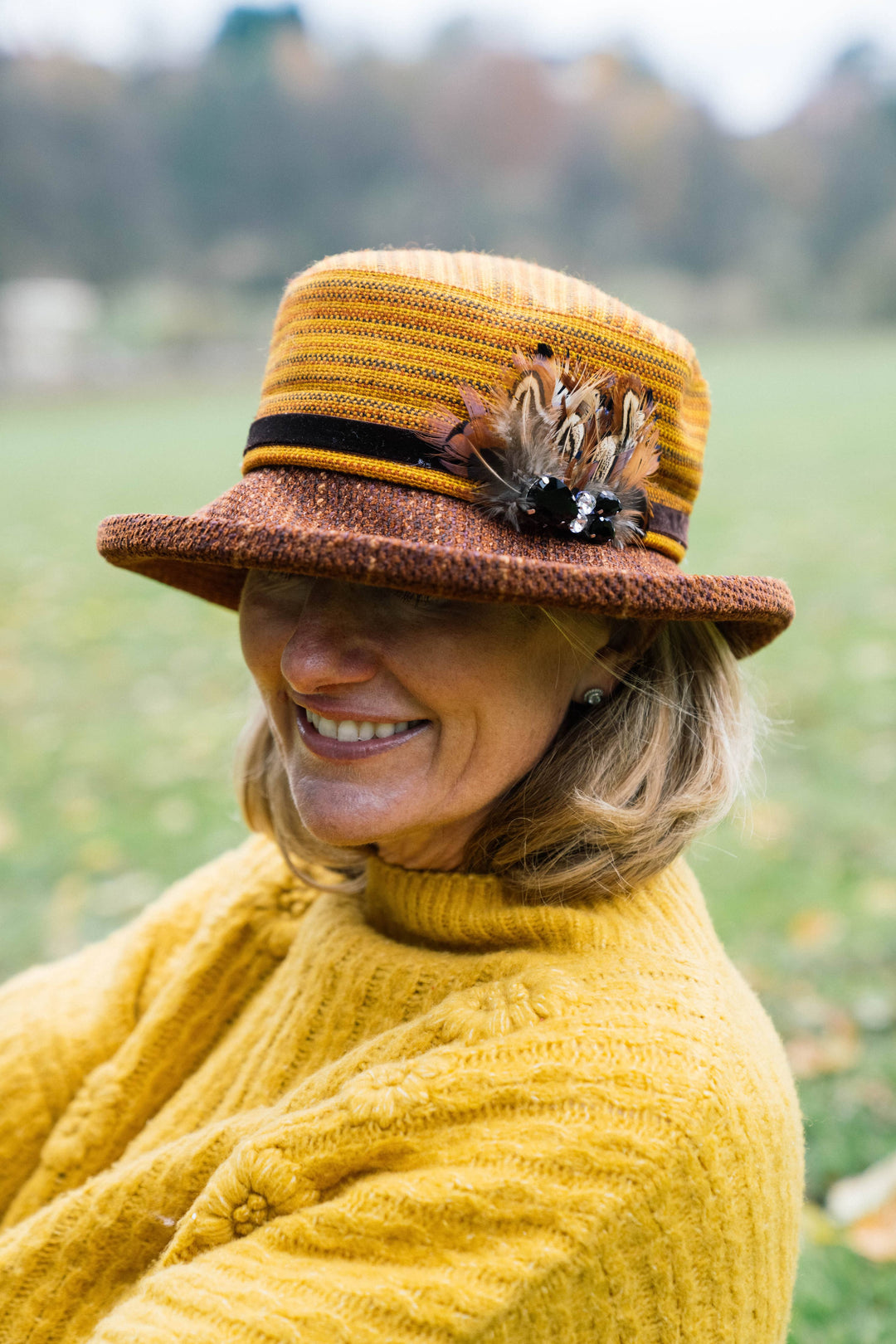 Limited Edition Autumn Woven Chenille Rich Autumn Coloured Hat with Feather Decoration.