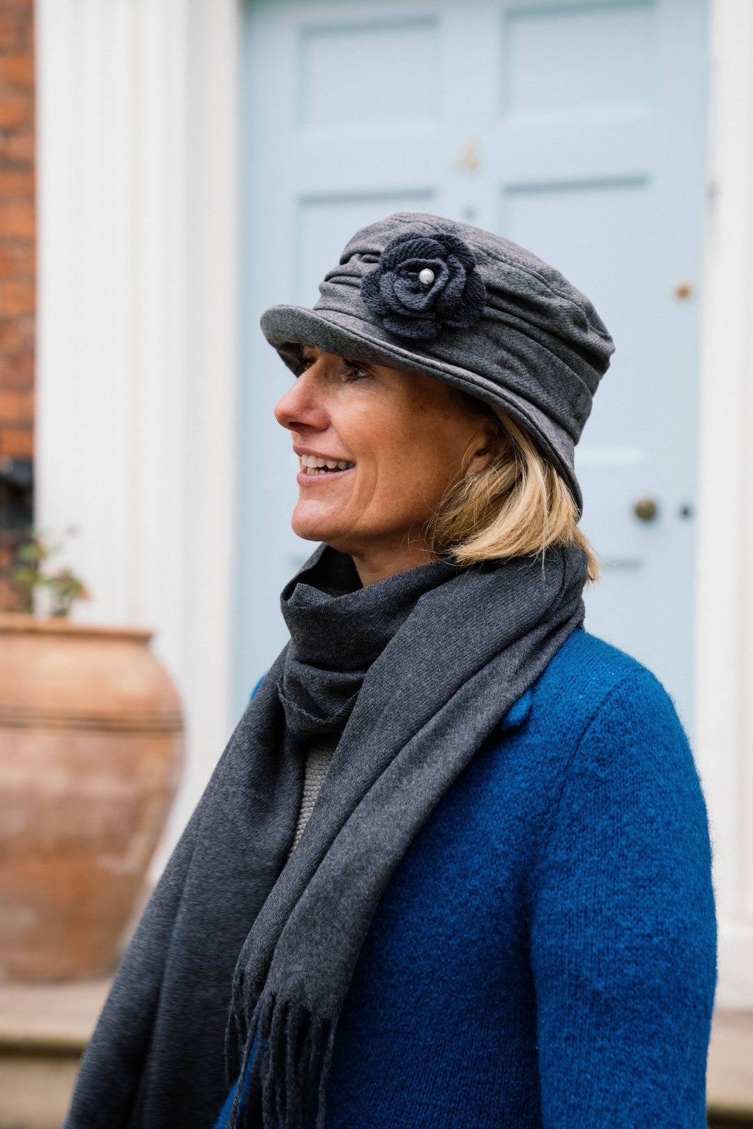 Soft Ruched Cloche Style Winter Hat Adorned With Textured Flower Trim